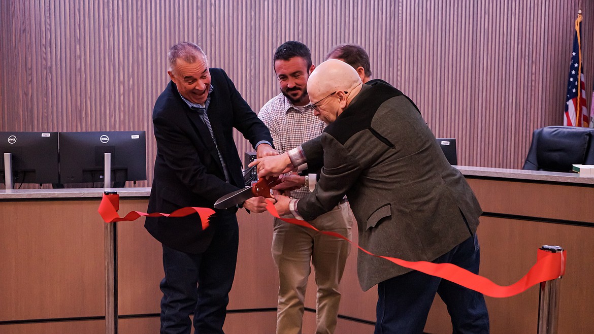 Flathead County officials, including County Commissioner Randy Brodehl, left, Justice Court Judge Paul Sullivan, center, and County Commissioner Brad Abell cut the ribbon on the new Justice Court building on Monday, Dec. 12. The remodeling of the 935 First Ave. W. building, which comes amid a shuffling of county agencies to make room for a fifth judge, cost a little more than $2 million. The dollars come from the county's PILT fund. "They've done a remarkable job," said District Court Judge Dan Wilson. "This is something that Flathead County can be proud of." (Photo courtesy Flathead County)