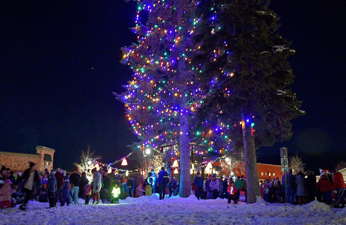 People gather around Depot Park for the tree lighting ceremony at the Whitefish Christmas Stroll on Friday. (Whitney England/Whitefish Pilot)