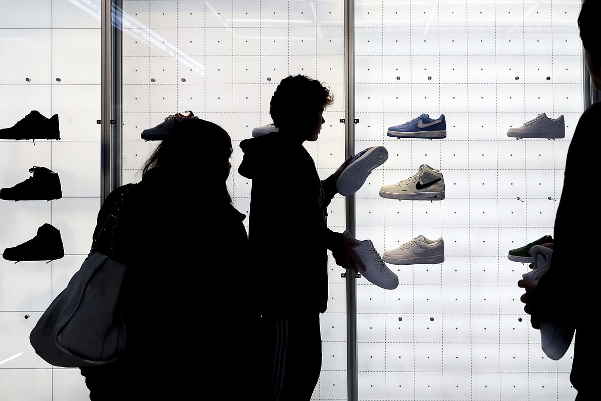 People shop for shoes in a Nike store on Black Friday, Nov. 25, 2022, in New York. On Tuesday, Dec. 13, the Labor Department reports on U.S. consumer prices for November. (AP Photo/Julia Nikhinson, File)