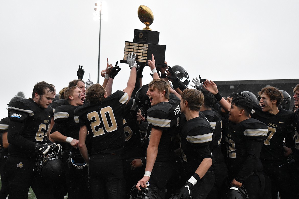 Players celebrate with the state championship trophy in 2021. The Royal Knights won the state championship in 2021 and 2019, making this year’s run a three-peat for the school.