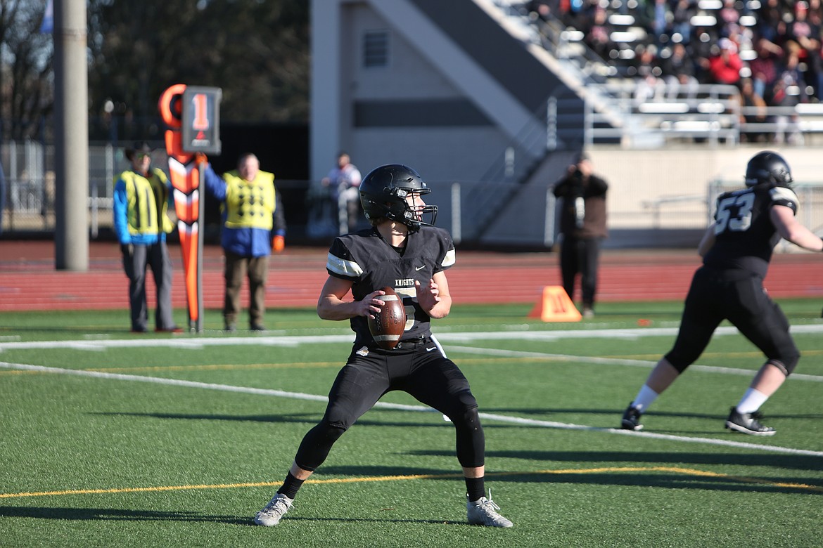 Royal senior quarterback Dylan Allred looks downfield for open receivers on the Knight’s first offensive drive of the 1A state championship game.