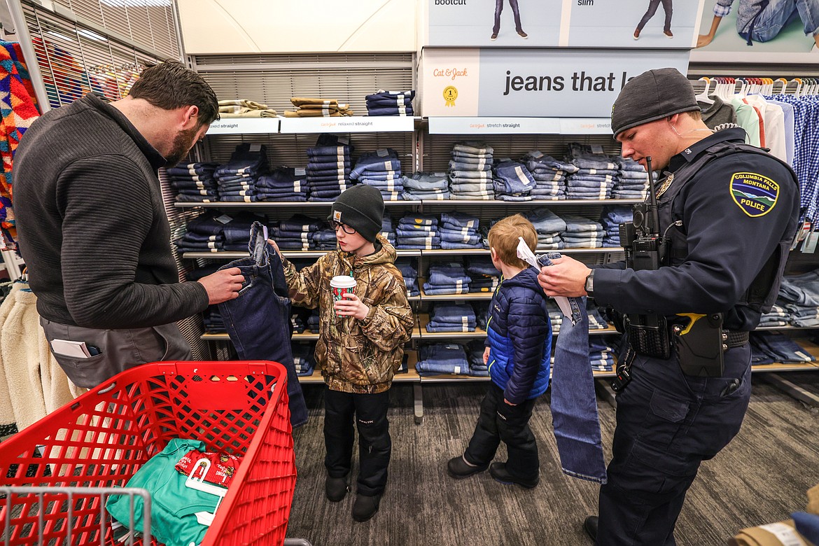 Columbia Falls police officers in the clothes section at Shop with a Cop. (JP Edge photo)