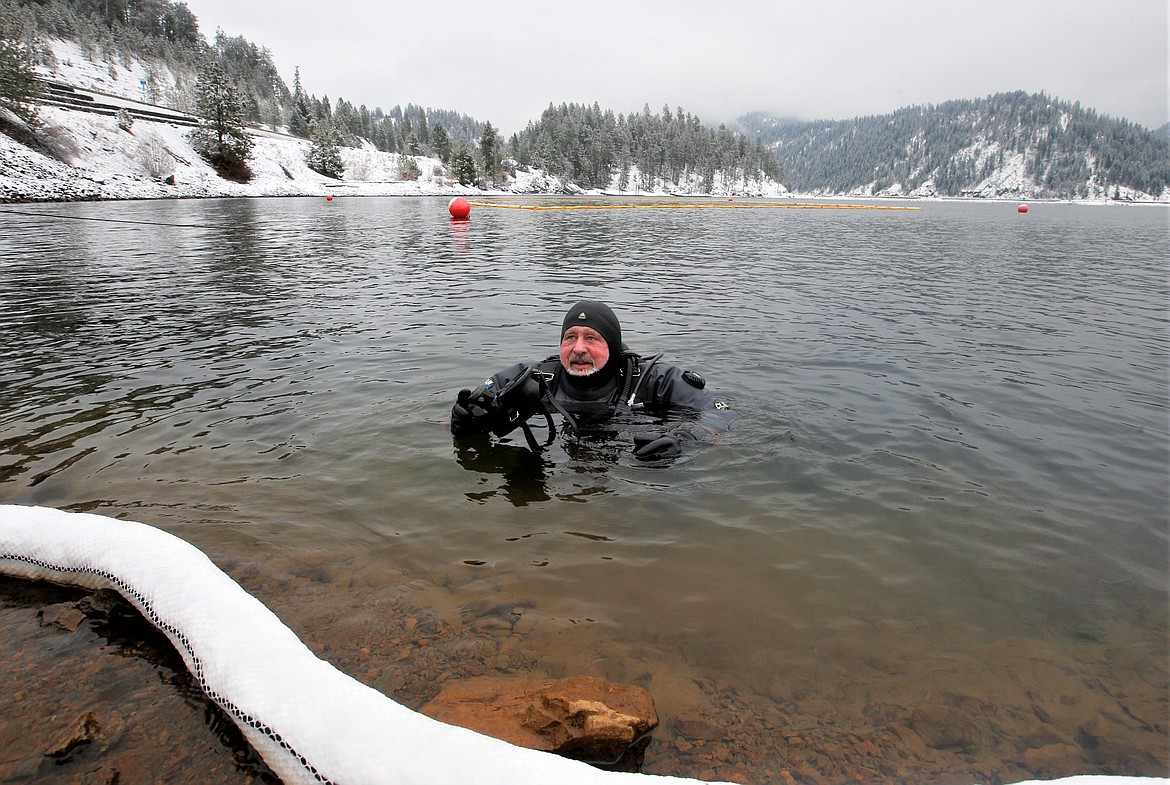 Eric Rouse emerges from a dive into Lake Coeur d'Alene at Higgens Point, where he was checking on the source of an oil leak Wednesday.