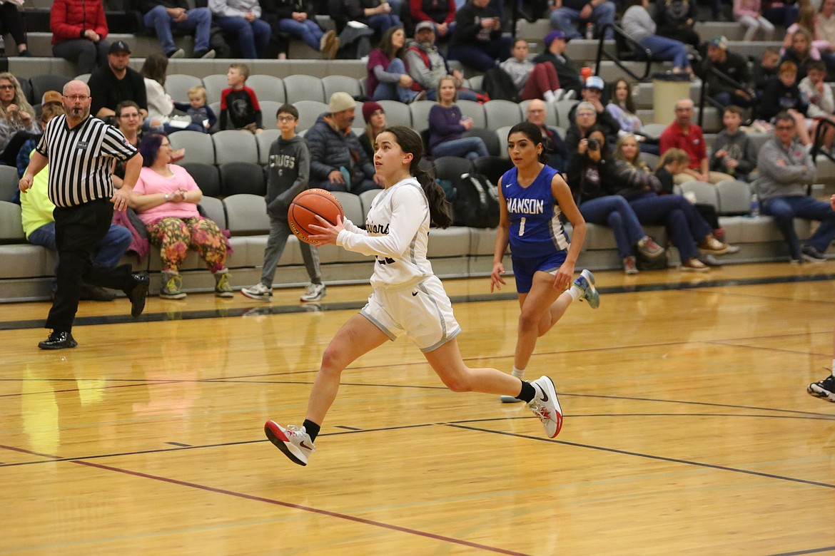 ACH junior Beth Okamoto runs down the court on a fast break, preparing to lay the ball up against Manson.