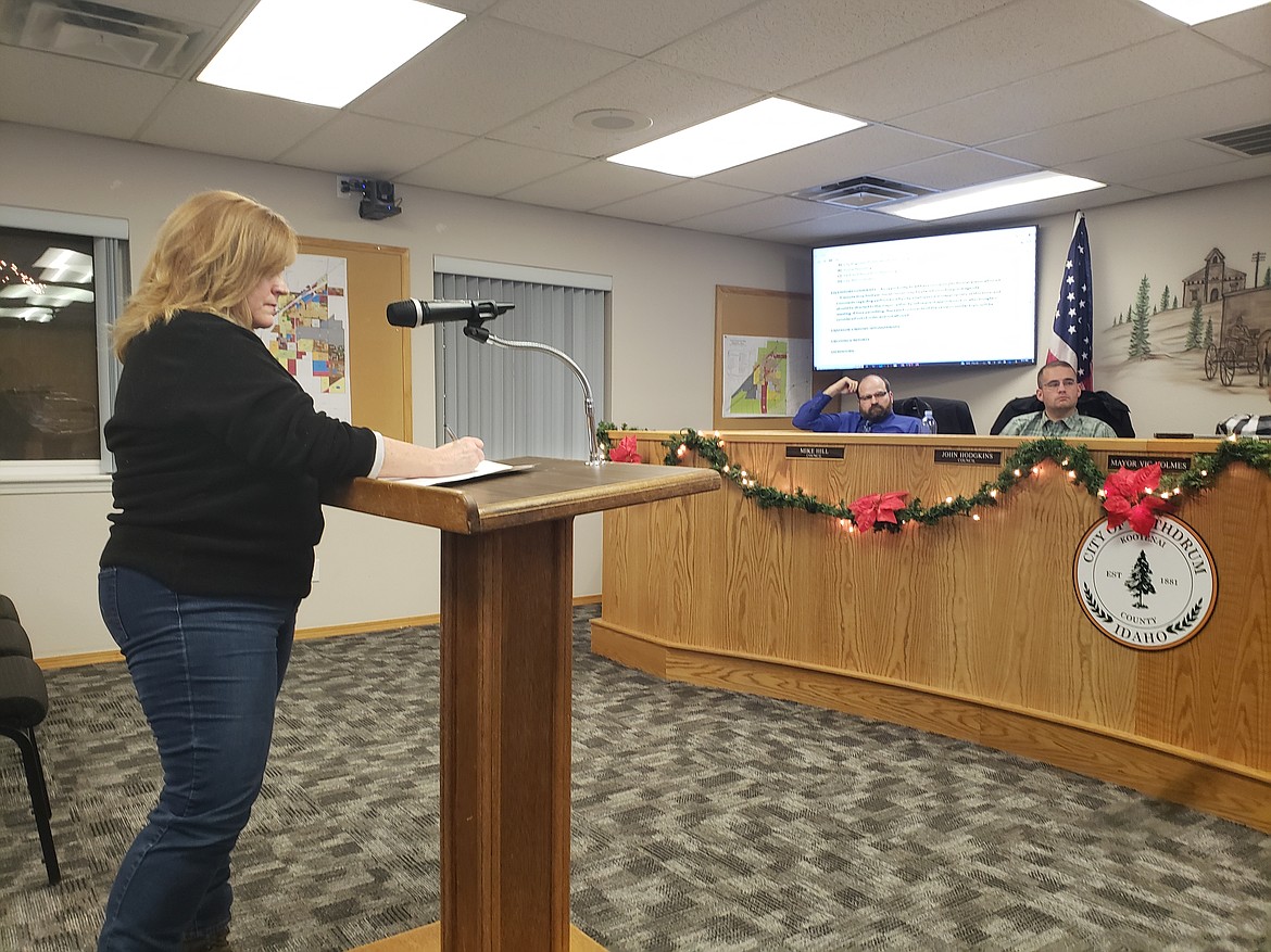 Shannon Belson speaks to Rathdrum City Council on Dec. 14, about a notification of a code violation she received in November asking her to remove her parking structure. She asked clarifying questions to council members, including Mike Hill and John Hodgkins, to help her understand the city code that prohibited the structure that has been there since she bought her home in 2021.