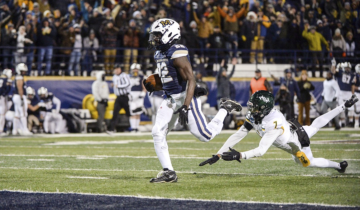 Montana State running back Isaiah Ifanse runs the ball into the end zone in the first half, avoiding a tackle by William & Mary’s Marcus Barnes during an NCAA football game Friday, Dec. 9, at Bobcat Stadium in Bozeman. (Rachel Leathe/Bozeman Daily Chronicle via AP)