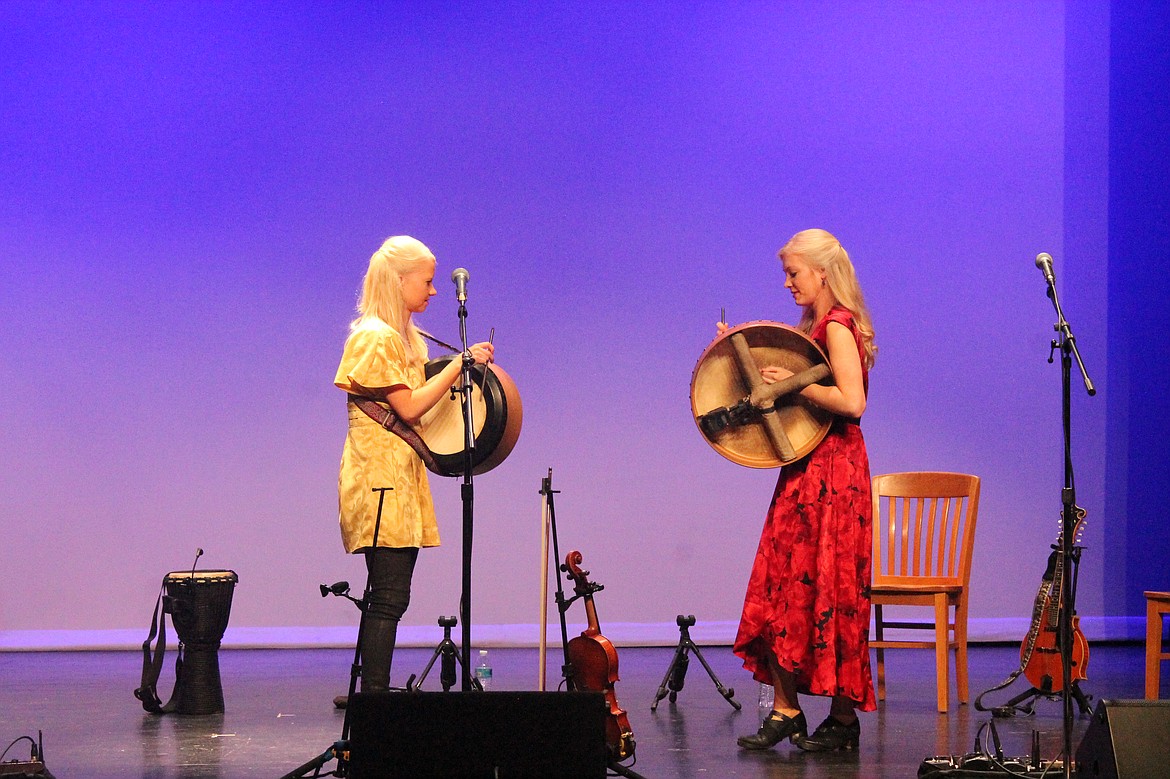 Solana, left, and Willow Gothard face off in “Double Bodhrans” at the Wallenstien Theater Tuesday. The bodhran is a traditional Celtic goatskin drum played with a single stick.