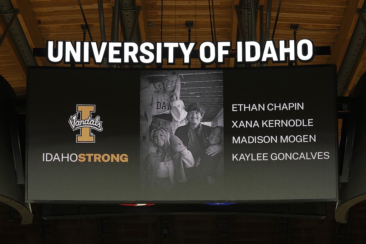 A photo and the names of four University of Idaho students who were killed over the weekend at a residence near campus are displayed during a moment of silence on Nov. 16.