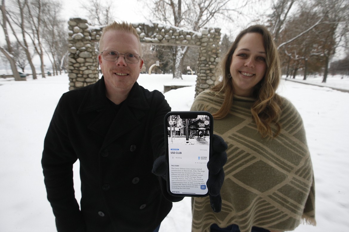 Chris Whalen, founder and CEO of Historik, and Museum of North Idaho Executive Director Britt Thurman stands at City Park on Friday. Whalen, via his mobile app, shows a picture of where a USO Club once stood at City Park.