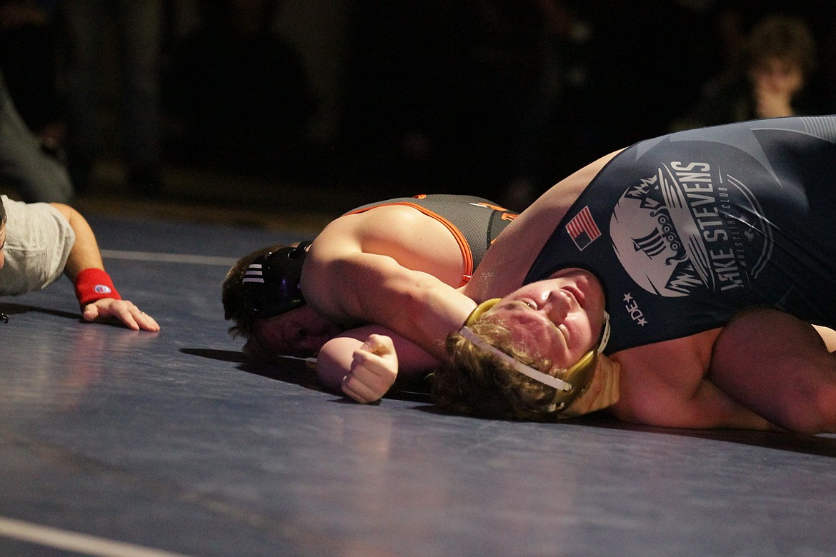 JASON ELLIOTT/Press
Post Falls senior Trevor Miller puts the shoulders of Koen Mattern of Lake Stevens to the mat during the 220-pound championship match at the Tri-State Invitational on Saturday at North Idaho College.