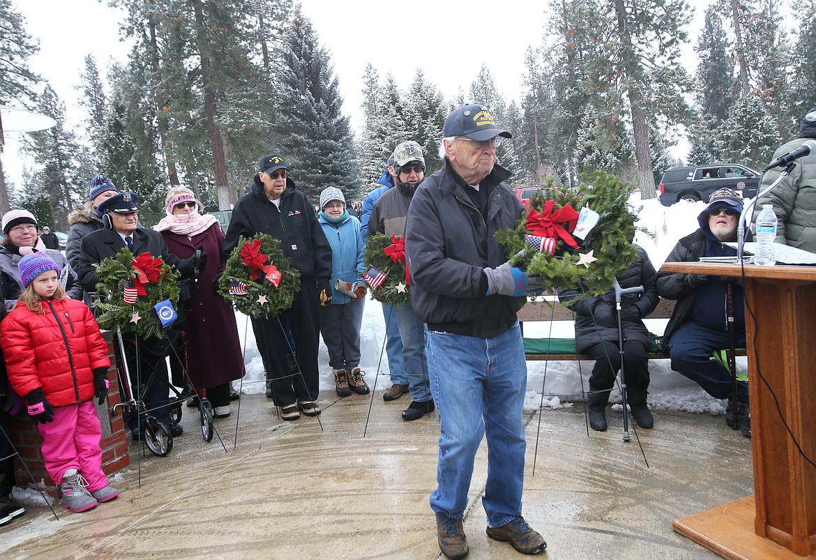 Army veteran Wayne Brewer, 93, prepares to place the Army remembrance wreath on the Rathdrum Veterans Memorial at Pinegrove Cemetery during a chilly Saturday morning Wreaths Across America ceremony.