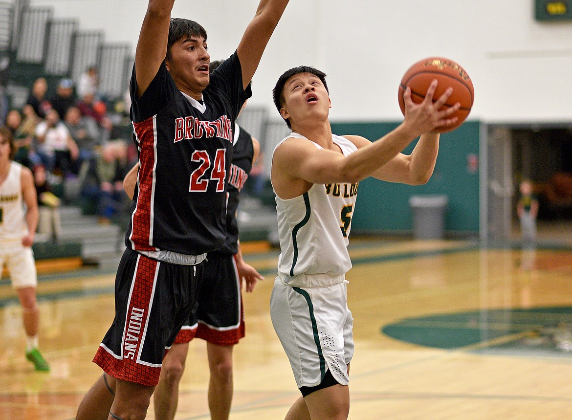 Bulldog Daniel To tries a reverse layup in a game against Browning on Saturday in Whitefish. (Whitney England/Whitefish Pilot)