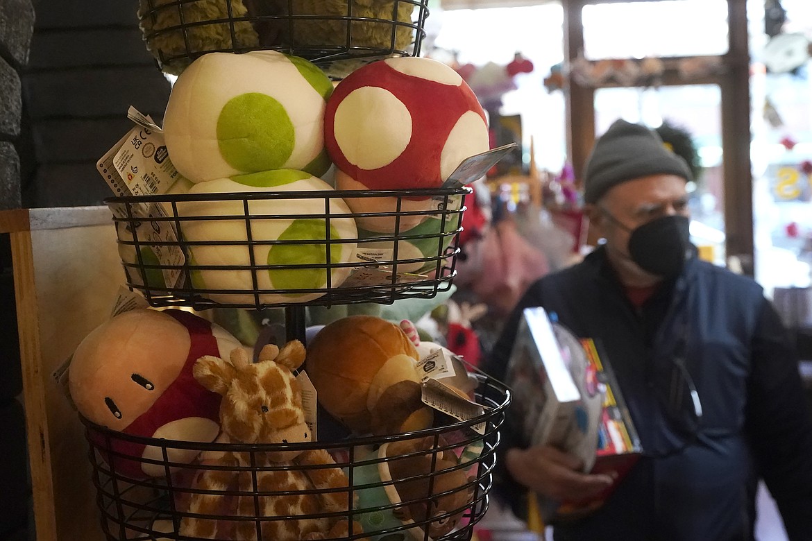 A basket of plush mushrooms and animals are shown as customers shop at a Five Little Monkeys store in Berkeley, Calif., Monday, Dec. 12, 2022. Small retailers say this year looks much different than the last "normal" pre-pandemic holiday shopping season of 2019. They're facing decades-high inflation forcing them to raise prices and making shoppers rein in the freewheeling spending seen in 2021 when they were flush with pandemic aid and eager to spend. (AP Photo/Jeff Chiu)