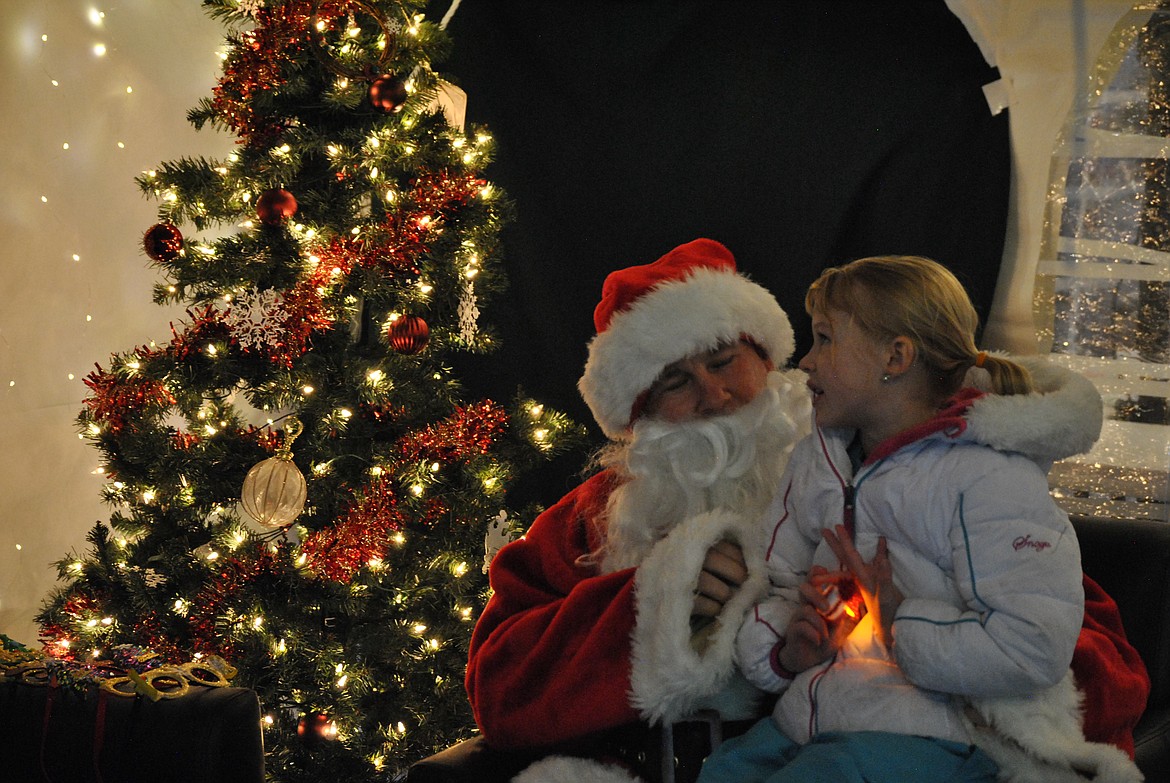 Gwen visits with Santa Claus last week during the Winter Festival at St. Regis School. (Mineral Independent/Amy Quinlivan)