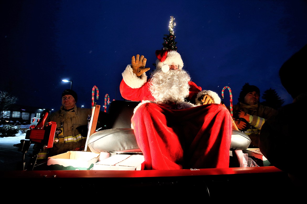 Firefighter Nick Pozzesi was Santa Claus for the Mobile Santa Food Drive on Monday, joined by firefighters Travis Georgius, right, and Tom Hiltenbrand acting as Santa's helpers.