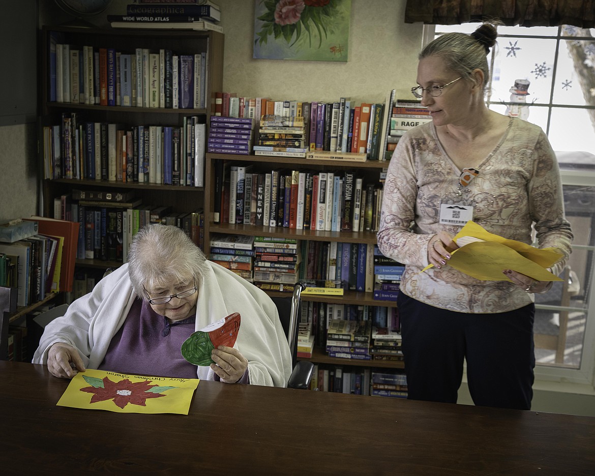 Nurse Dollie Valgamore gives resident Sharon Wilson a personalized Christmas decoration. (Tracy Scott/Valley Press)