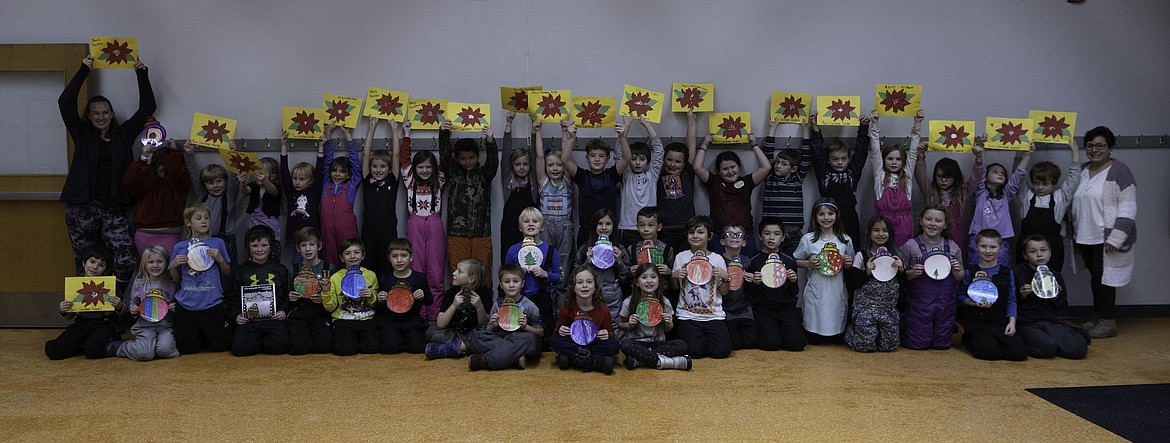 Plains Elementary 2nd Graders hold up decorations they made for long-term care residents. (Tracy Scott/Valley Press)