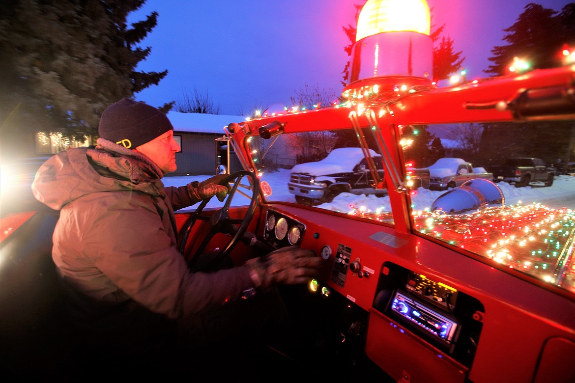 Firefighter Mike Fredrick drives the Mobile Santa Food Drive fire truck on Monday.