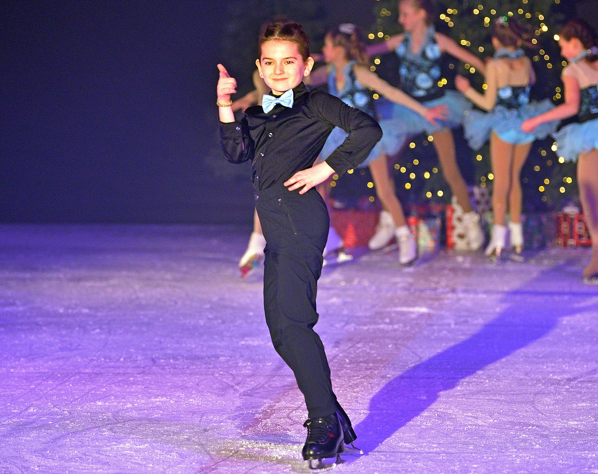 Braxten Quimby smiles at the crowd during the Glacier Skate Academy show 'Winter Wonderland on Ice' at the Stumptown Ice Den on Saturday. (Whitney England/Whitefish Pilot)