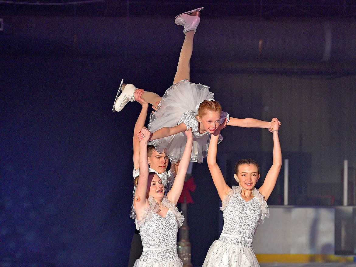 London Taylor is lifted by Kaile Jensen, Isabella Mitchell and Andrew Hawken during the Glacier Skate Academy show 'Winter Wonderland on Ice' at the Stumptown Ice Den on Saturday. (Whitney England/Whitefish Pilot)