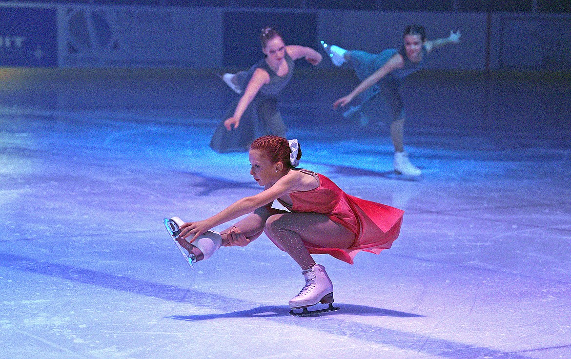 Skaters London Taylor, front in red dress, Natalie Blythe and Kalea Squires perform during the Glacier Skate Academy show 'Winter Wonderland on Ice' at the Stumptown Ice Den on Saturday. (Whitney England/Whitefish Pilot)