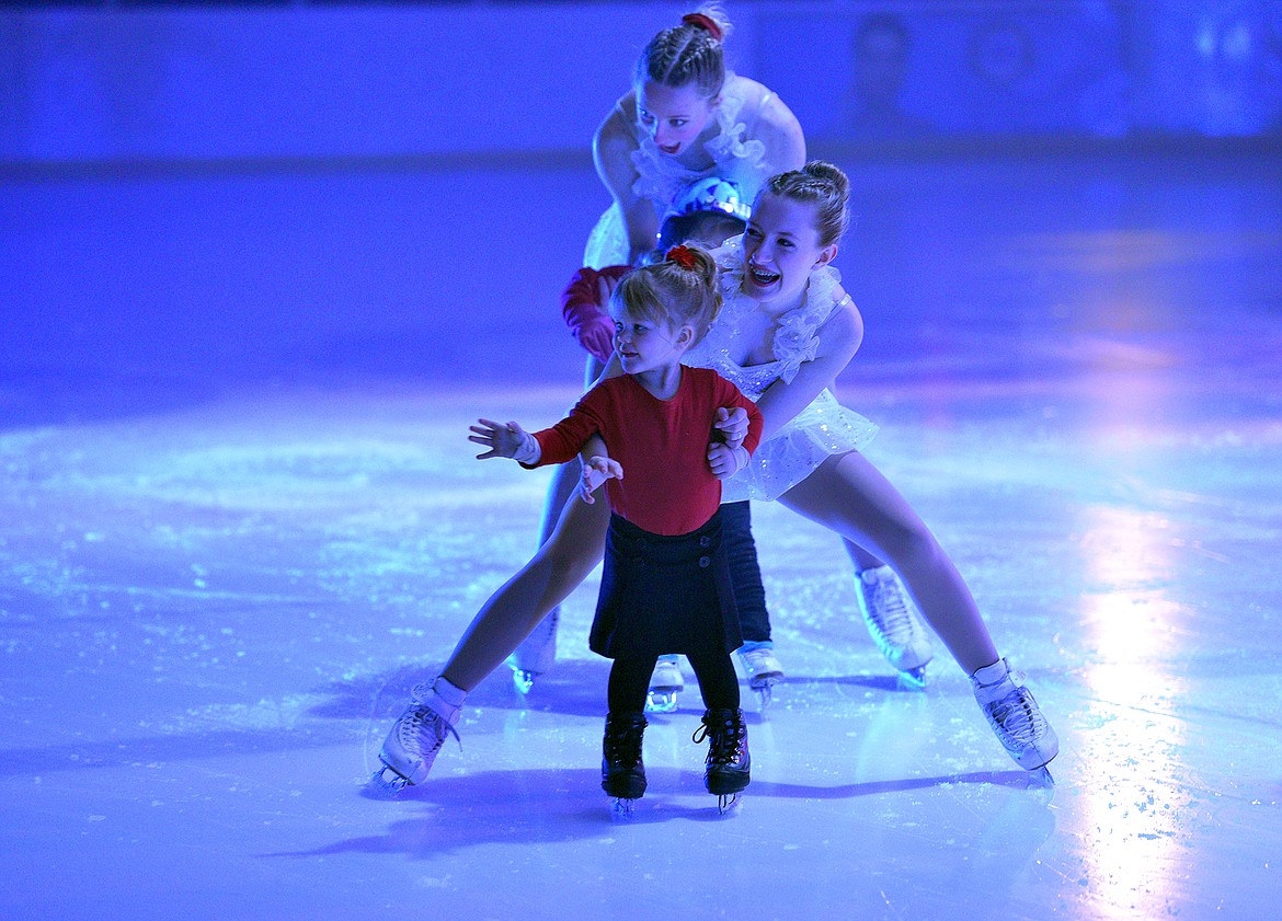 Young skater Lilian Lindsey is assisted by Kaile Jensen and Emma Marlowe during the Glacier Skate Academy show 'Winter Wonderland on Ice' at the Stumptown Ice Den on Saturday. (Whitney England/Whitefish Pilot)