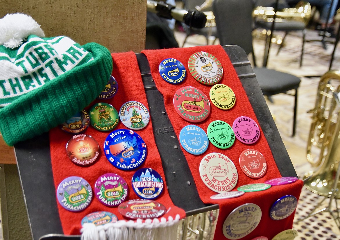 TubaChristmas was established in 1974 and a button for the worldwide concert event is released each year. Allen Slater, the organizer of the Kalispell event, displays his collection Monday evening at the concert at the Red Lion Hotel. (Heidi Desch/Daily Inter Lake)