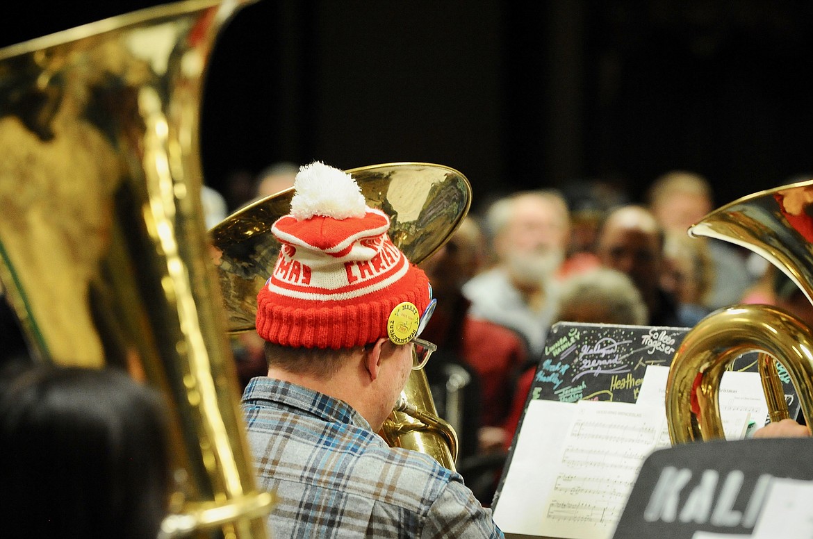 A musician wears a TubaChristmas stocking hat while playing during the TubaChristmas concert Monday at the Red Lion Hotel. (Heidi Desch/Daily Inter Lake)
