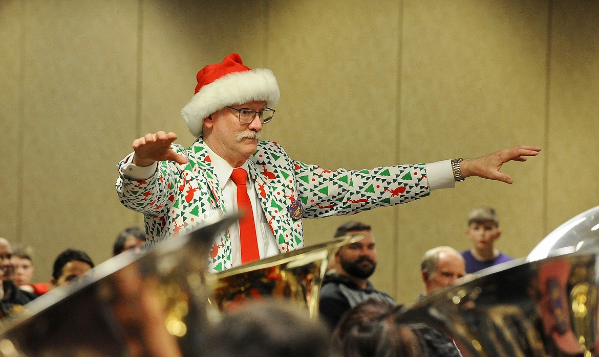 Allen Slater, retired Flathead High School band director, conducts the band Monday for the TubaChristmas concert at the Red Lion Hotel. Slater has been organizing the Kalispell event for the last 25 years. (Heidi Desch/Daily Inter Lake)