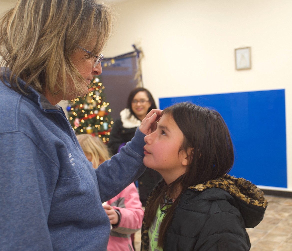 Amy Vaughan, director of operations for Boys & Girls Clubs of the Flathead Reservation and Lake County, talks to a young visitor at Mission's new club. (Kristi Niemeyer/Lake County Leader)