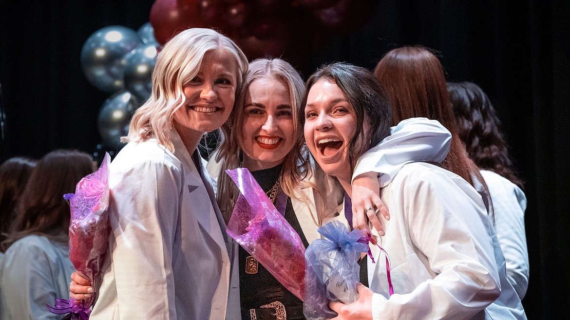 From left, Carli Daniels of Hayden, Jessica Reineccius of Spirit Lake and Abbey Leon of Rathdrum celebrate their graduation from NIC’s Dental Hygiene program onstage Wednesday, Dec. 14 at Boswell Hall Schuler Performing Arts Center on NIC’s main campus in Coeur d’Alene.