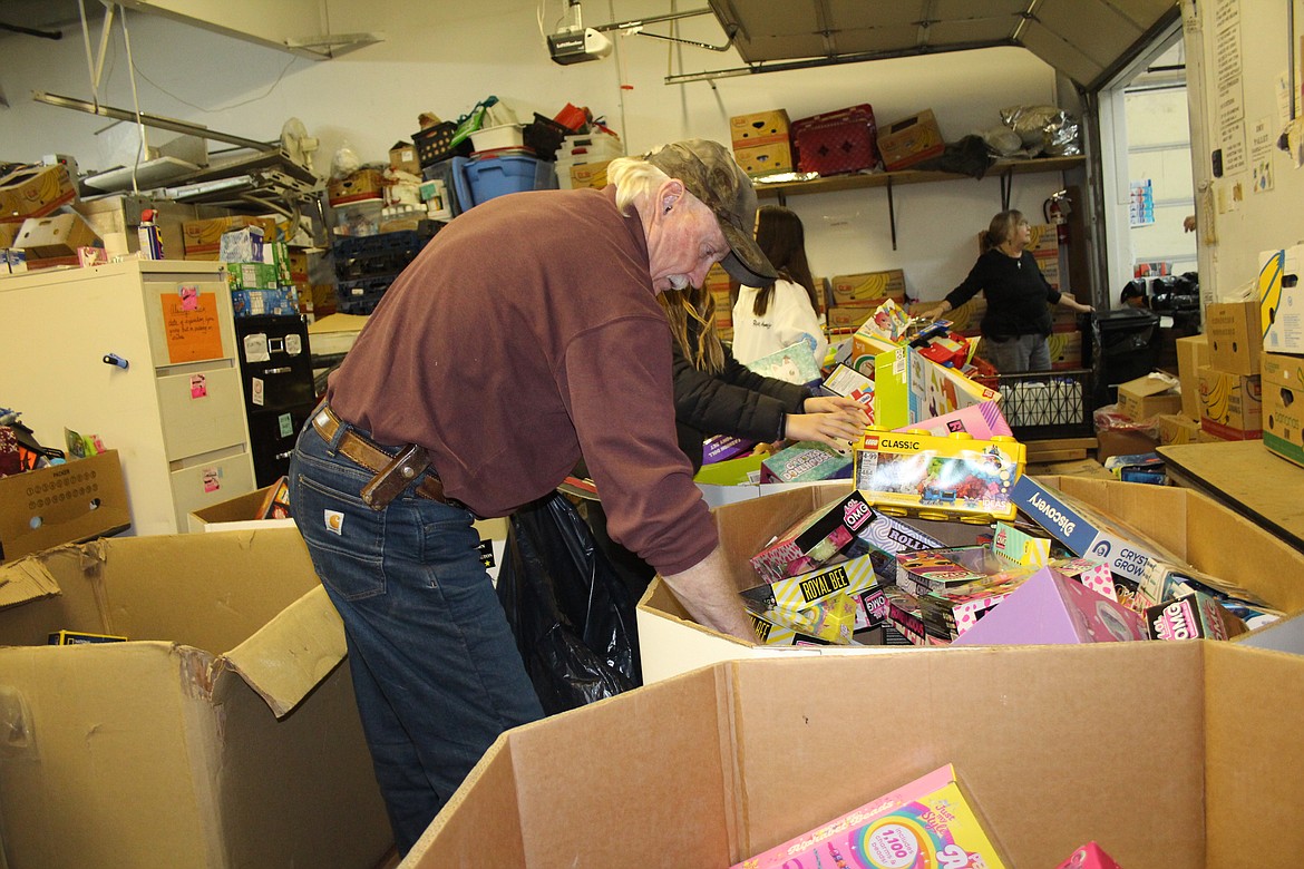 Dale Casebolt picks toys from a bin for distribution during Operation Friendship toy pickup day.