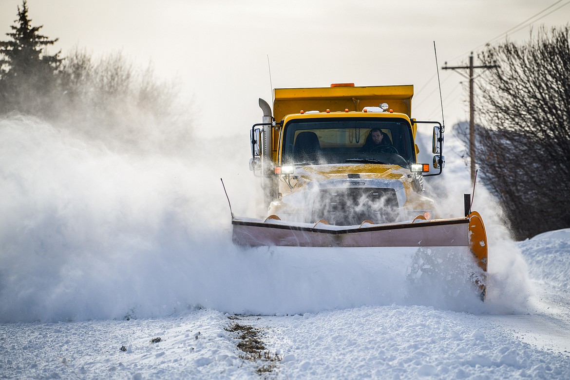 A snow plow operator clears Somers Stage Road on Wednesday, Dec. 21. (Casey Kreider/Daily Inter Lake)