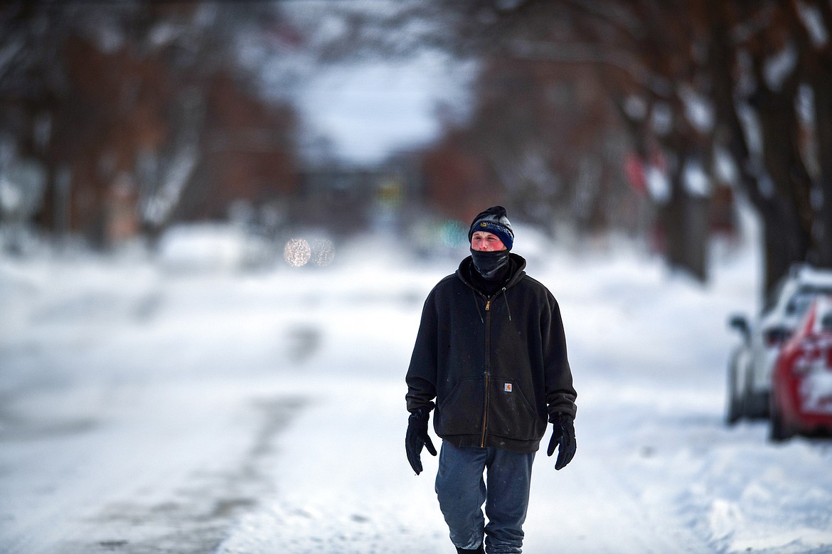 A man bundles up for a walk in subzero temperatures along Second Street West in Kalispell on Wednesday, Dec. 21. (Casey Kreider/Daily Inter Lake)