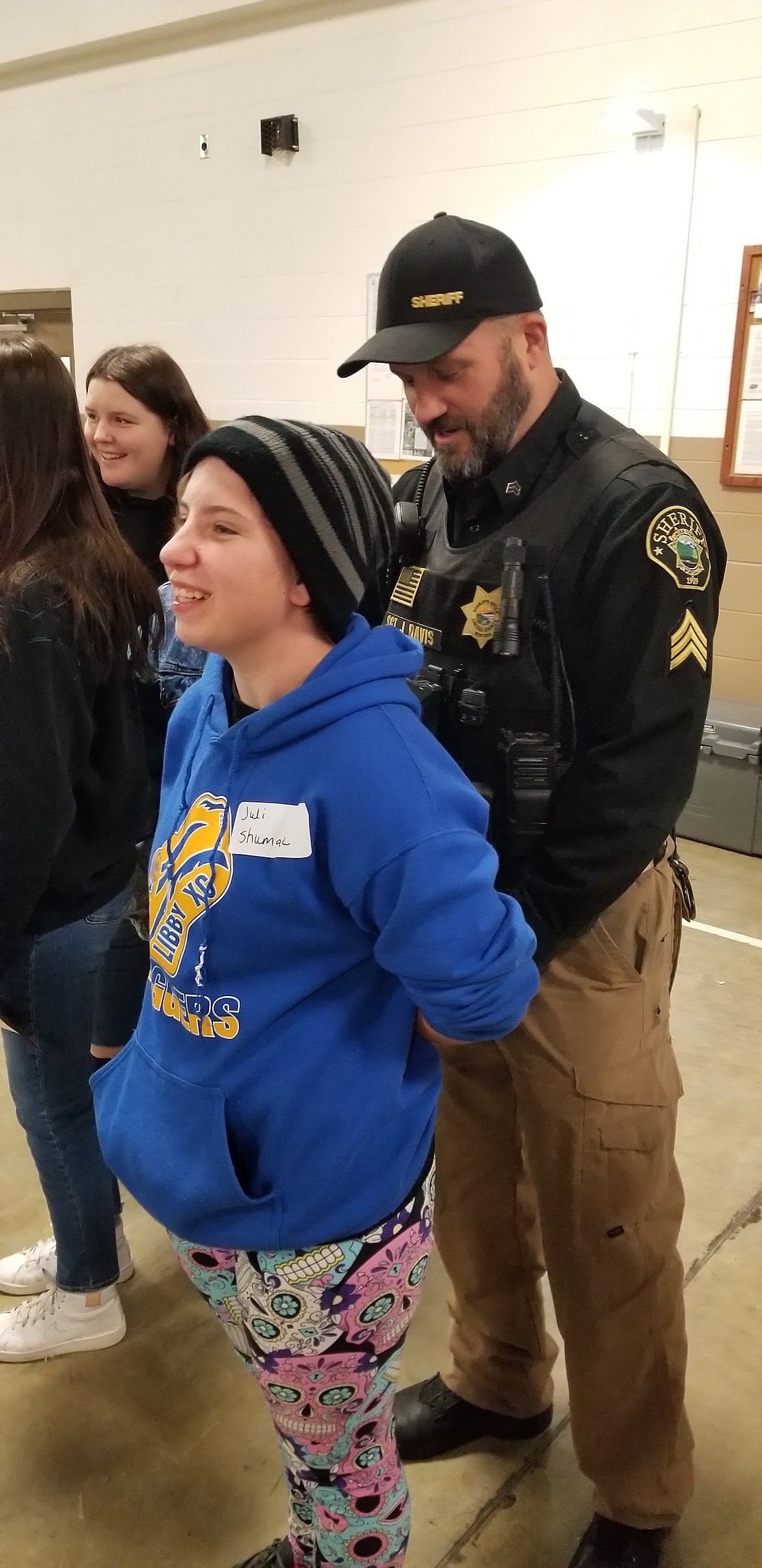 Lincoln County Sheriff's Office Sgt. Jon Davis shares a laugh with Juli Shumate while showing her handcuffs are used on Dec. 15. (Photo courtesy Jerica O'Neil)