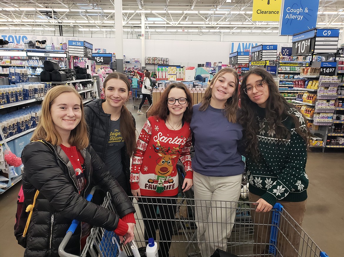 From left, Lake City High students Taylah Chapman, Taylor Meredith, Kaya Hernandez, Ashley Carpenter and Clara Tenbrink meet Wednesday for a shopping spree at the Walmart in Hayden. They helped raise over $10,500 with their senior economics class to buy Christmas presents for local families.