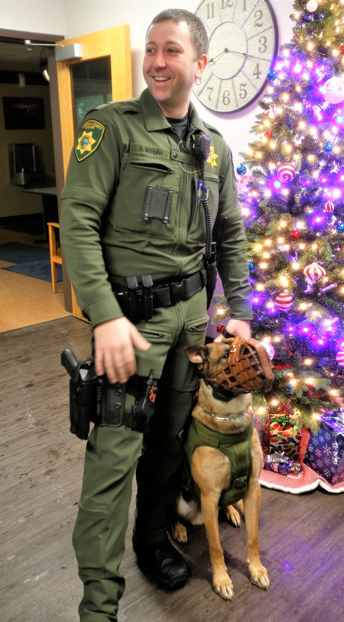 Kootenai County Sheriff's Deputy Robert Imthurn stands with Deuce at the Kootenai County Sheriff's Office on Wednesday during a meeting with the Coeur d'Alene Dog Fanciers.