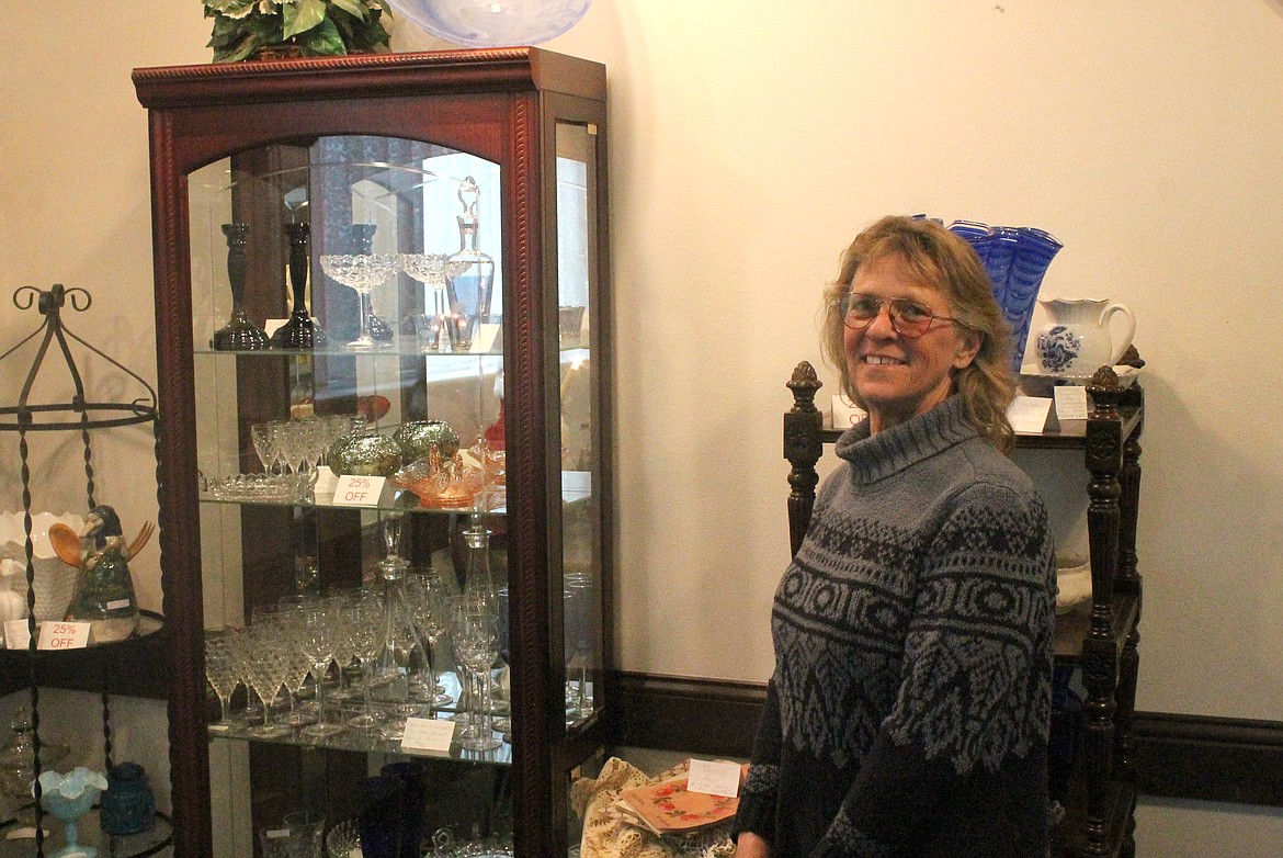 Patricia Hulett smiles in the corner of Java Bloom, the coffee, floral and antique shop she owns with her husband Bill in Washtucna.