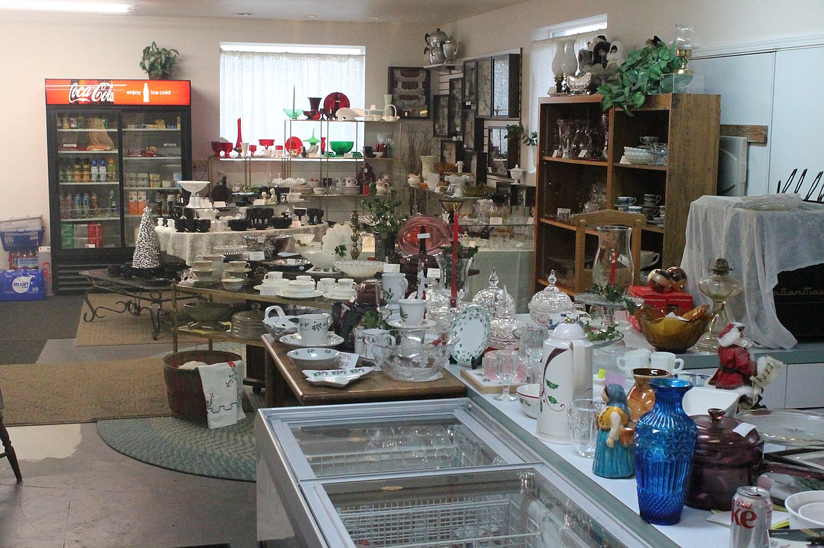 Mixed in with the coolers and freezers at Java Bloom are tables and shelves of antiques and fine glassware.