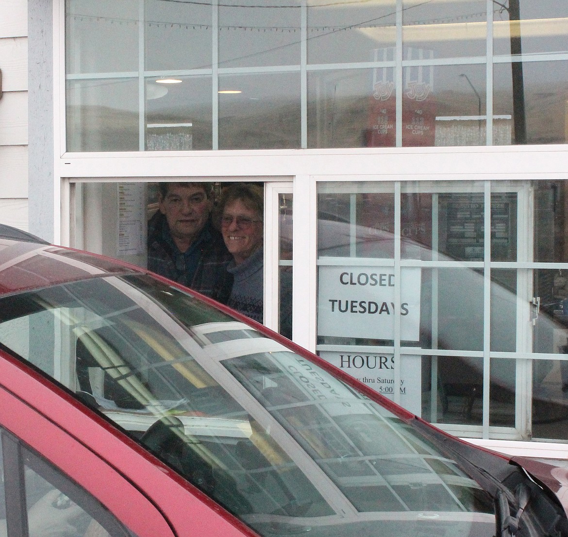 Bill, left, and Patricia Hulett chat with a customer after handing her coffee order to her at Java Bloom in December.