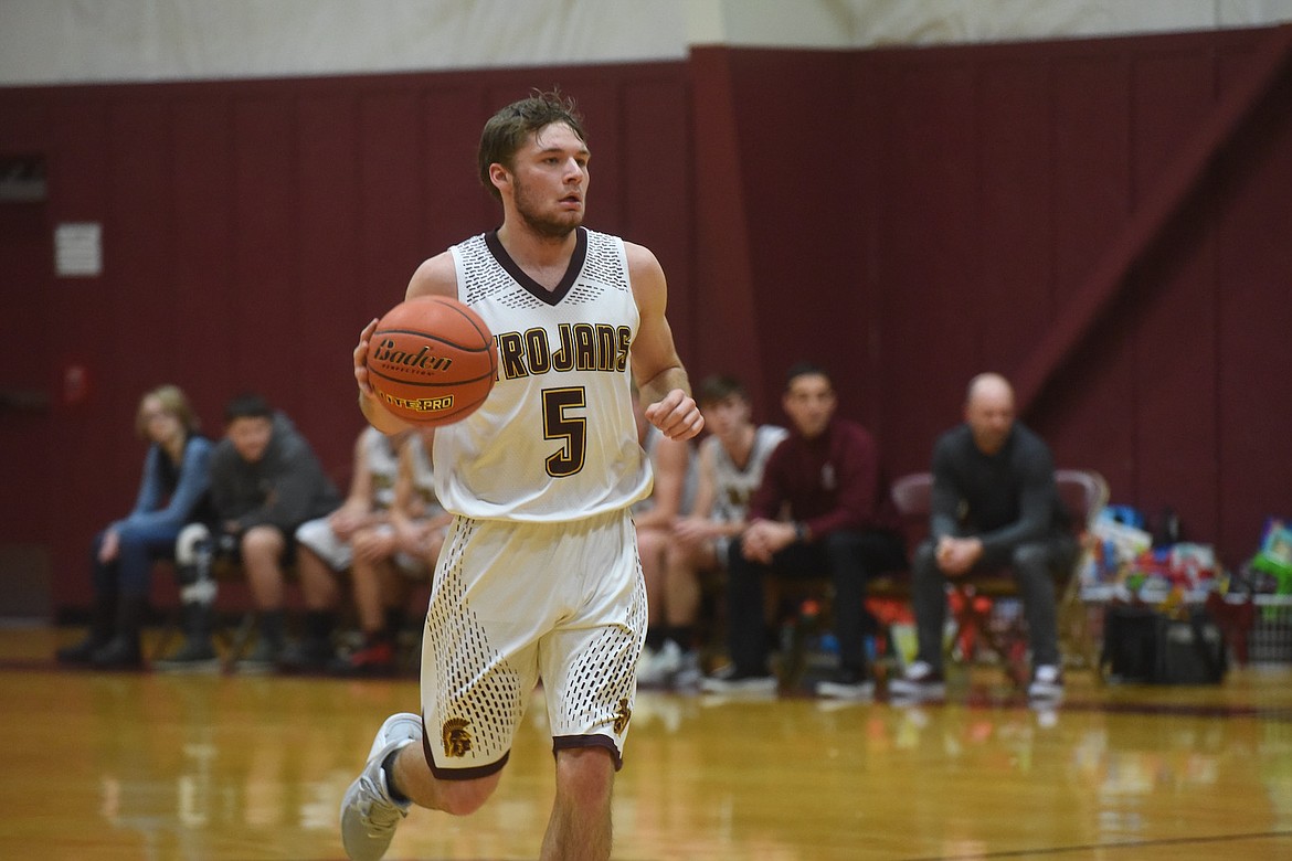 Troy's Paxton Fisher dribbles the ball during Wednesday's game against Libby. (Scott Shindledecker/The Western News)