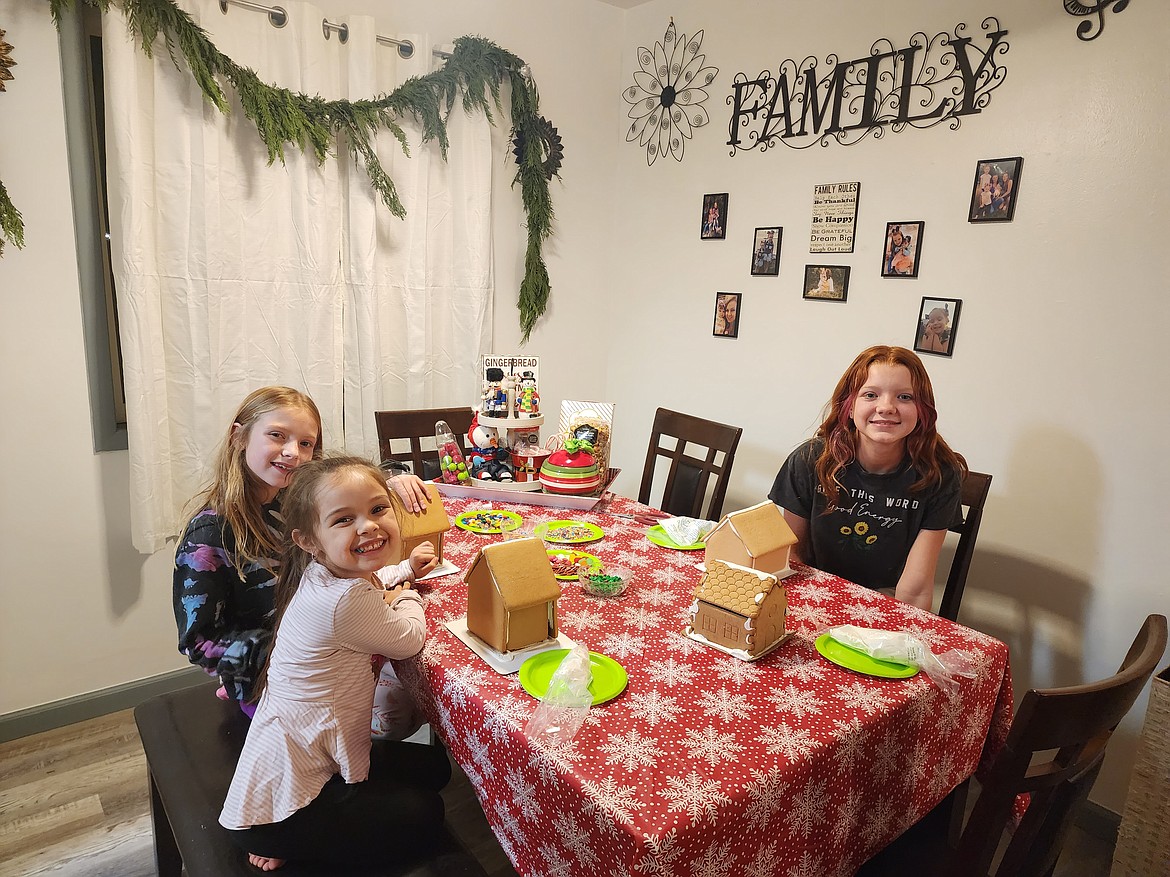 Receptionist Jeannie Austin's three children decorate cookies in preparation for the Christmas holiday.