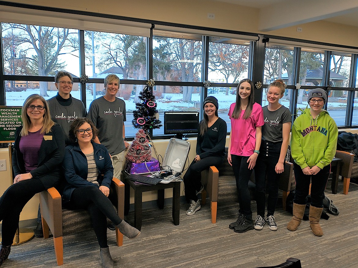 Code Girls United’s advanced program installed a light display at Stockman Bank in Kalispell. From left to right are Tonya Solomon with Stockman Bank, Paula Ferguson with Code Girls United, Sarah Cathcart with Stockman Bank, Amy Moore with Code Girls United, Kary Meschke with Stockman Bank, Makayla Davenport, Isabelle Ashley and Willow Truman. (Courtesy photo)