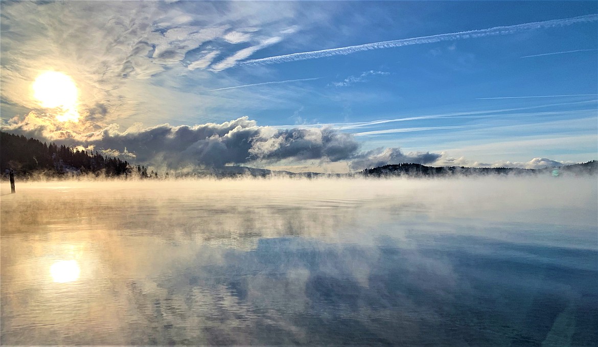 The sun rises over Tubbs Hill as mist rises above Lake Coeur d'Alene on Thursday morning.