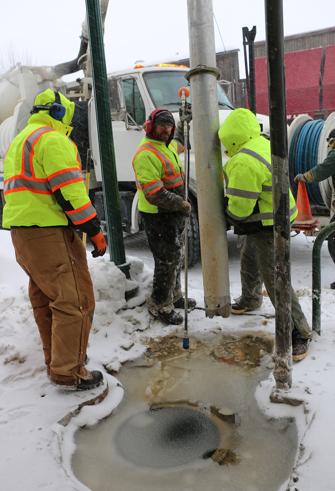 Sandpoint crews work to fix a service line break in downtown Sandpoint Friday morning. Thought to have been caused by frozen pipes, the service line break led to a flooded street and water being shut off to some businesses until repairs could be made.