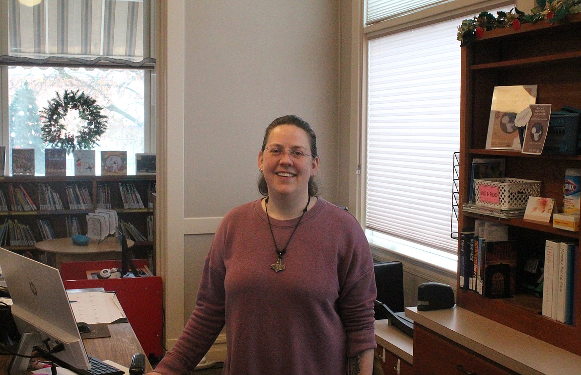 Millie Hopkins, circulation manager at the Ritzville Library, stands behind the library’s counter in December. Hopkins has been with the library for about five years.