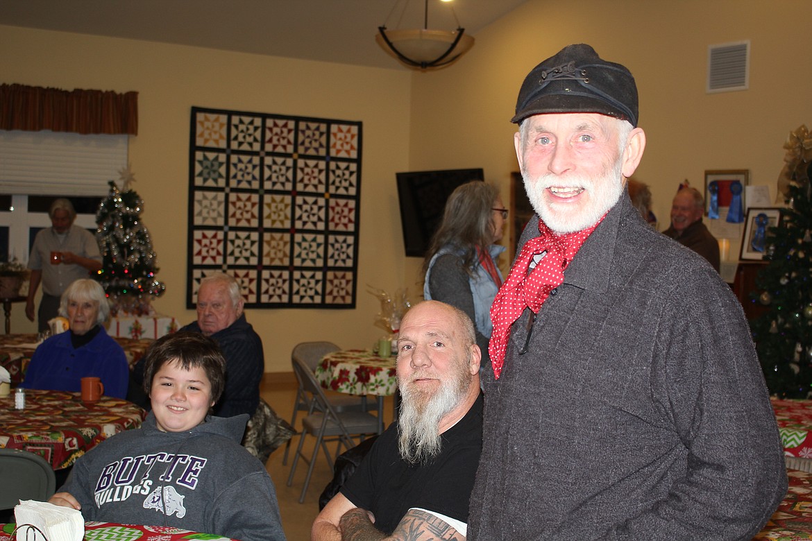 Tom Heacock visits with friends at the St. Regis Senior Citizens Center Christmas dinner. (Monte Turner/Mineral Independent)