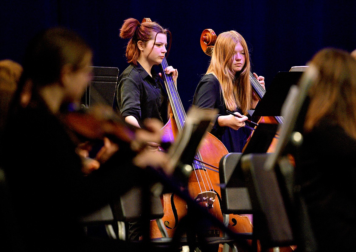 Students Mosby Stiffler and Isla Perkins play the bass during the Whitefish High School and Middle School winter orchestra concert at the Performing Arts Center on Dec. 6. (Whitney England/Whitefish Pilot)