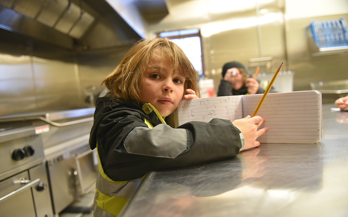 Luca Spagna shows his drawing of the the kitchen in the food bank on a recent field trip in Whitefish. (Julie Engler/Whitefish Pilot)