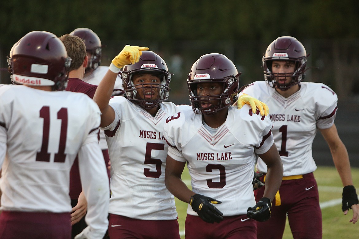 Moses Lake junior Kyson Thomas (5) celebrates with teammate Joel Middleton after a touchdown against Ephrata. Thomas said that he and Middleton have been playing sports together since he was little.